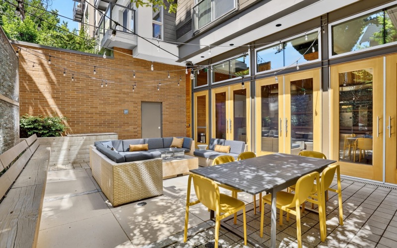 a patio with a couch, table and chairs