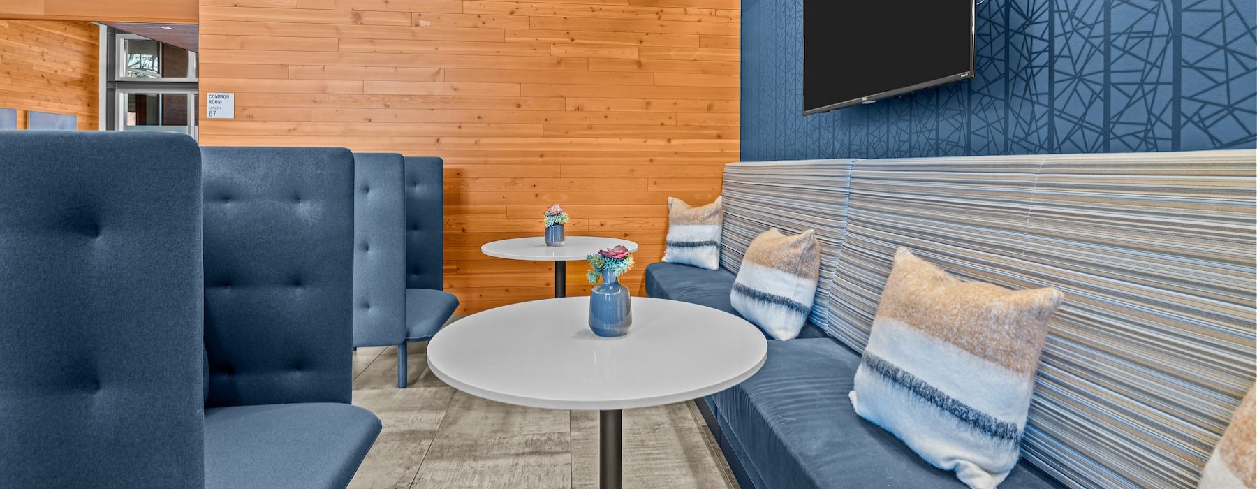 a room with tables, couches and a booth