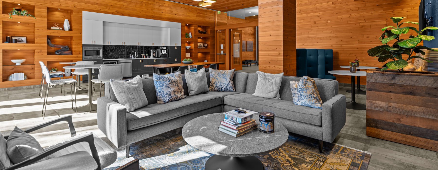 a clubroom with a couch, tables and chairs