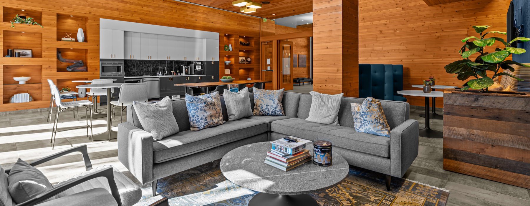 a clubroom with a couch, tables and chairs